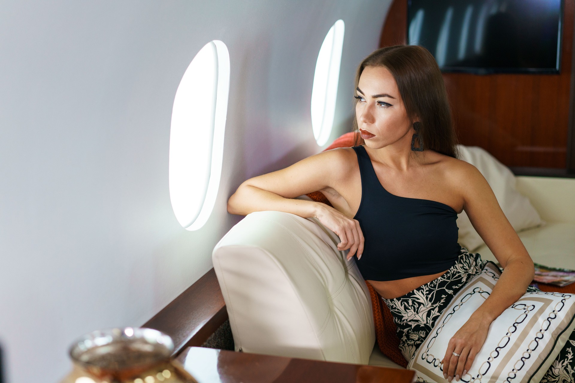 Ideal Woman. A Modern Woman In Stylish Clothes Is Smiling While Sitting